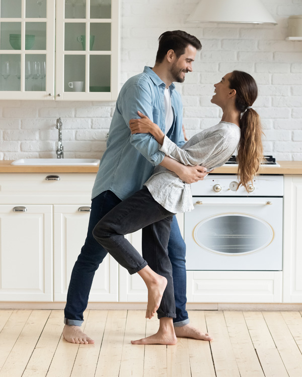 Happy couple dancing in kitchen